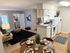 Cozy and stylish open-plan living space with a modern kitchen, chic dining area, and inviting lounge featuring elegant decor and natural light.