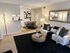Elegant living space featuring a modern sofa, chic floor lamp, and contemporary dining area, perfect for stylish apartment living.