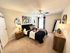 Chic and inviting bedroom with plush carpeting, modern artwork, and stylish lighting, creating a cozy retreat.
