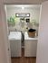 Modern laundry room with energy-efficient washer and dryer, wooden floors, and stylish decor.