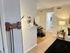 Cozy apartment interior featuring a modern open layout, warm lighting, and stylish furnishings with a small dining area and inviting living space.