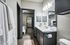 Elegant bathroom featuring dual sinks, modern fixtures, and spacious layout with connecting bedroom and walk-in closet.