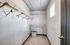 Spacious walk-in closet with modern shelving and natural light, perfect for organized living.