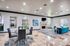 Elegant living area featuring a stylish, open-concept design with modern furniture, a cozy fireplace, and bright natural lighting through arched windows.