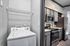 Modern apartment features a sleek kitchen with stainless steel appliances and an in-unit washer for ultimate convenience.