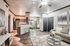 Chic open-concept living space featuring a cozy living room with plush seating, a sleek kitchen with modern appliances, and an elegant dining area with contemporary decor.