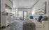 Bright and inviting living room with elegant white decor, plush sofa, and large windows offering abundant natural light.