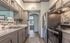 Modern kitchen with sleek granite countertops, stainless steel appliances, and elegant cabinetry, offering a stylish and functional space.