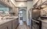 Modern kitchen with sleek stainless steel appliances, elegant cabinetry, and a stylish backsplash, offering a chic and functional culinary space.