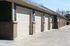 Row of modern, sleek garages with brick accents, offering secure and convenient parking solutions.