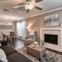 Elegant living room with cozy seating, chic decor, and a stylish fireplace, perfect for relaxation.