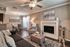 Inviting living room with elegant decor, featuring a cozy fireplace, plush seating, and modern lighting accents.