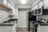 Contemporary kitchen with sleek black countertops, modern stainless steel appliances, and stylish tile backsplash.