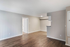 Bright and airy apartment featuring elegant hardwood flooring, fresh neutral walls, and an inviting nook area.