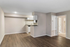 Modern apartment with elegant wood flooring, featuring an open-plan kitchen and bright living area for a cozy lifestyle.