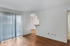 Bright and airy living space with elegant wooden floors and large sliding glass doors, perfect for natural light enthusiasts.