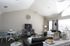 Elegant living space with vaulted ceilings, plush seating, modern decor, and abundant natural light.