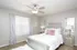 Elegant bedroom with modern gray decor, plush bed, and soft lighting creating a cozy ambiance.
