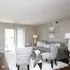Luxurious living room with elegant gray sofa, plush armchairs, and modern decor in a bright, airy space.