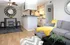 Contemporary open-plan living space with stylish furniture, modern decor, and an inviting kitchen area, perfect for comfortable urban living.