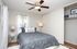 Bright and cozy bedroom with a plush bed, modern decor, and ample storage space in a serene apartment.