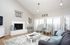Bright and inviting living room with a cozy fireplace, elegant decor, and ample natural light from large windows.