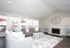Bright and elegant living room with plush seating, stylish decor, and natural light streaming through large windows.