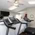 Bright and modern fitness room equipped with advanced treadmills and flat-screen TV, perfect for an invigorating workout.