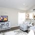 Modern living room with elegant grey furniture, stylish white accents, and a cozy atmosphere, ideal for relaxation and entertainment.