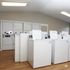 Modern laundry room equipped with multiple washers and dryers, offering convenience and efficiency for residents.