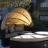 Inviting outdoor seating with canopy in a serene apartment courtyard, perfect for relaxation.