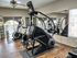 Modern fitness room with high-end StairMaster, sleek exercise bikes, and mirrored walls featuring natural light.
