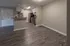 Modern kitchen with sleek appliances, stylish countertops, and elegant wood flooring in a spacious open-plan apartment.