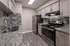 Modern kitchen with sleek granite countertops, stainless steel appliances, and stylish backsplash.