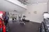 Modern fitness room with state-of-the-art equipment, bright natural lighting, and sleek design for an invigorating workout experience.