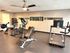 Inviting fitness room equipped with modern exercise machines, motivational wall quotes, and a sleek design for an energizing workout experience.