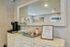 Chic apartment interior showcasing a welcoming entryway with a vintage dresser, elegant mirror, and stylish decor, creating a cozy and inviting atmosphere.