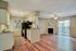 Bright and inviting open-plan kitchen and living area with hardwood floors, modern cabinetry, and a cozy fireplace. Perfect for entertaining with ample natural light.