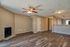 Modern open-plan living area with warm wood flooring, cozy fireplace, and inviting natural light.