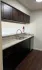 Chic modern kitchen with elegant granite countertops and a welcoming drink setup, perfect for entertaining.