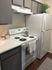 Modern kitchen featuring sleek white appliances, elegant cabinetry, and a chic countertop, perfect for stylish urban living.