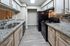 Modern kitchen with sleek granite countertops, elegant cabinetry, and stainless steel fixtures, perfect for culinary adventures.