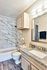 Elegant bathroom design with a marble-tiled shower, granite countertop, and soft lighting for a luxurious feel.