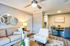 Chic and inviting living area with modern decor, cozy seating, stylish round dining table, and contemporary lighting.