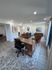 Chic and modern open space with stylish furniture, large windows, and elegant decor, perfect for relaxation and productivity.