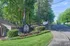 Charming community entrance at The Villages, featuring lush greenery and a welcoming pathway.