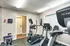 Inviting fitness room featuring modern exercise equipment and a bright, welcoming atmosphere.