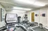 Modern apartment fitness center with state-of-the-art exercise equipment, bright lighting, and stylish decor perfect for health enthusiasts.