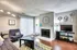 Chic living room with modern decor, featuring a cozy fireplace, stylish furniture, and vibrant accents for a warm, inviting ambiance.