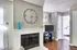 Charming living space with a cozy fireplace, stylish decor, and inviting natural light, perfect for relaxation and comfort.